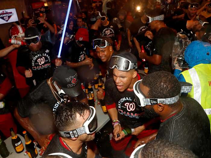 Oct 15, 2019; Washington, DC, USA; Washington Nationals celebrate in the locker room after defeating the St. Louis Cardinals in game four of the 2019 NLCS playoff baseball series at Nationals Park. Mandatory Credit: Geoff Burke-USA TODAY Sports
