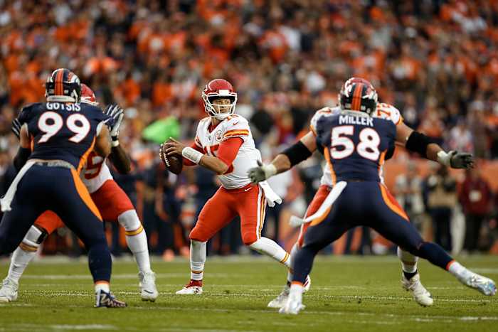 Oct 1, 2018; Denver, CO, USA; Kansas City Chiefs quarterback Patrick Mahomes (15) drops back to pass as offensive lineman Cameron Erving (75) and offensive tackle Eric Fisher (72) block against Denver Broncos defensive end Adam Gotsis (99) and linebacker Von Miller (58) in the first quarter at Broncos Stadium at Mile High.