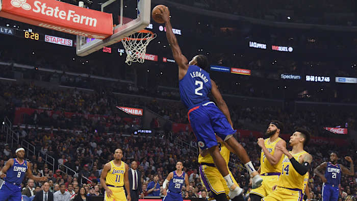 Kawhi flushes a left-handed dunk in the Clippers' season-opening win over the Lakers.