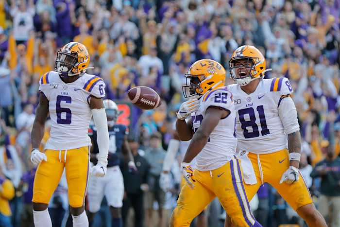 LSU running back Clyde Edwards-Helaire (22) celebrates his touchdown with tight end Thaddeus Moss (81) and wide receiver Terrace Marshall Jr. (6) in the second half of an NCAA college football game against Auburn in Baton Rouge, La., . LSU won 23-20