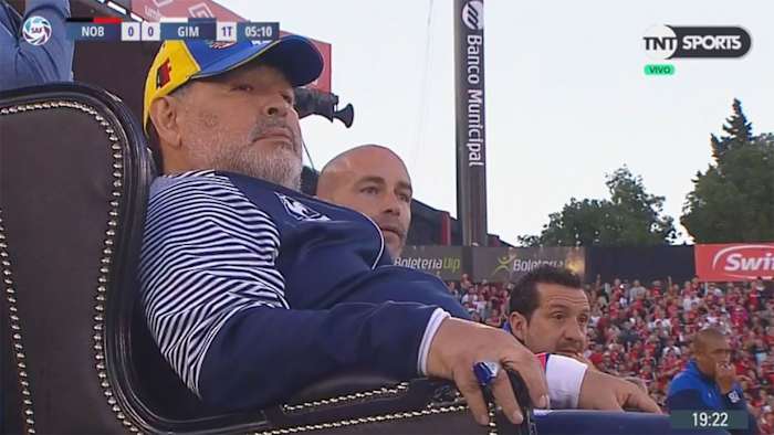 Diego Maradona coaches from a throne