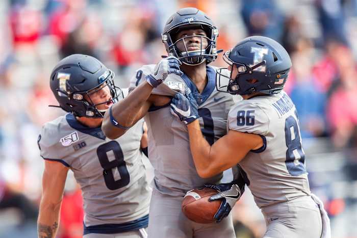 Illinois wide receiver Josh Imatorbhebhe (9) celebrates a touchdown with wide receiver Casey Washington (8) and wide receiver Donny Navarro (86) during a game against Wisconsin at Memorial Stadium.