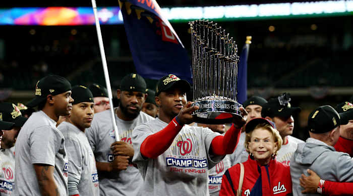 Oct 30, 2019; Houston, TX, USA; Washington Nationals left fielder Juan Soto hoists the Commissioners Trophy after defeating the Houston Astros in game seven of the 2019 World Series at Minute Maid Park. The Washington Nationals won the World Series winning four games to three. Mandatory Credit: Troy Taormina-USA TODAY Sports