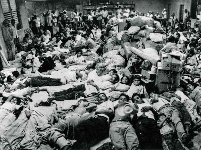Salvadorian nationals who were residing in Honduras arrive at the Red Cross headquarters in San Miguel on July 7, 1969. Following the armed conflict between El Salvador and Honduras, 14,000 nationals residing in Honduras returned to their country.