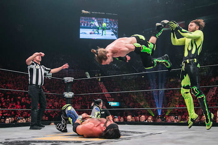 South African luchador Angélico (standing) and his American tag team partner Jack Evans.