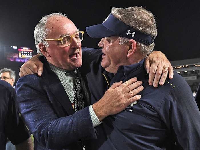 Notre Dame AD Jack Swarbrick (left) and coach Brian Kelly celebrate after the Irish capped off a 12–0 regular season with a win at USC on Nov. 24, 2018.