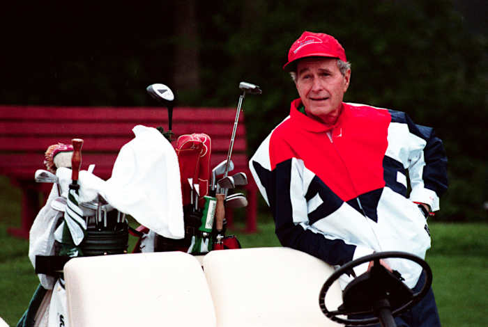 Bush with his golf clubs in 1991.