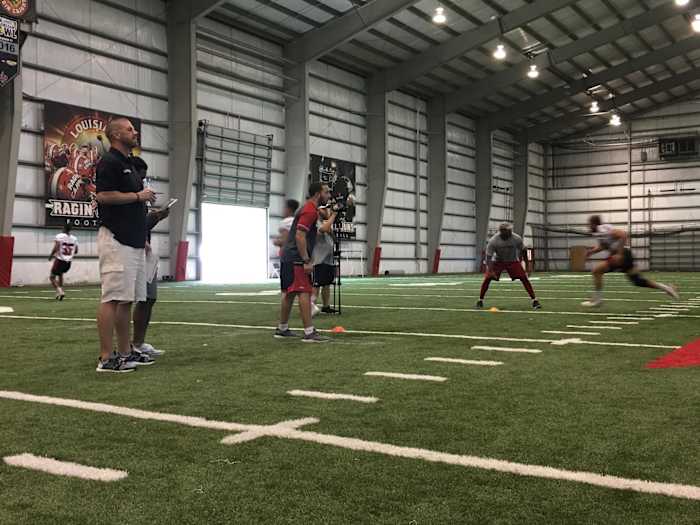 Billy Napier watches walk-ons participate in workouts inside Louisiana’s indoor facility.
