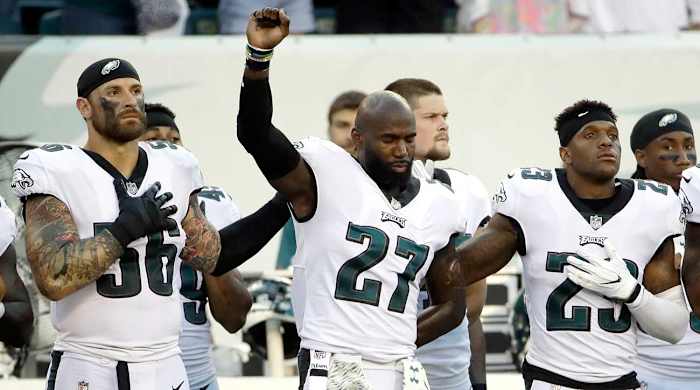 Chris Long, Malcolm Jenkins and Rodney McLeod stand in solidarity before the Eagles-Dolphins game. Jenkins began raising his fist during the 2016 season.