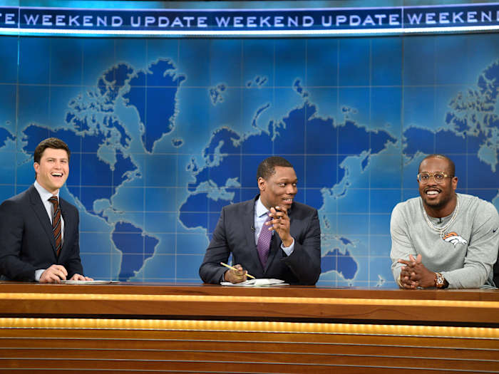 Miller, with comedians Colin Jost and Michael Che, during his "Weekend Update" appearance on Saturday Night Live.