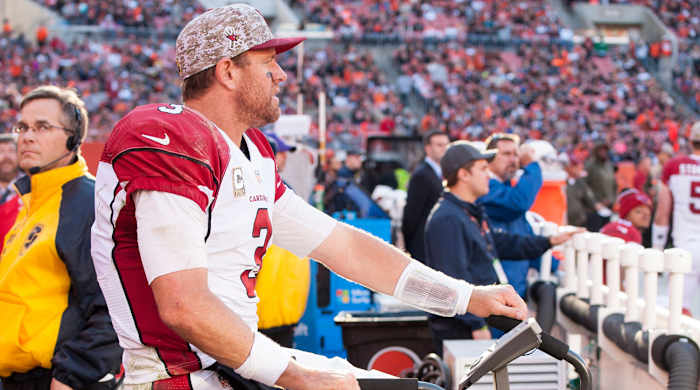 Palmer’s playsheet wristband is visible as he rides the stationary bike.