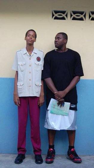 Labissiere, at age 13, stands with Pierre Valmera at Quisqueya Christian School in Port-au-Prince in Dec. 2009.