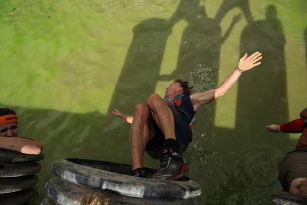 Murphy drops into water after completing Sewage Outlet obstacle during Tough Mudder's Beta Test Event.