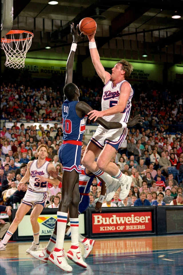 Manote Bol #10 of the Washington Bullets blocks a shot attempt by Mark Olberding #53 of the Sacramento Kings during a game played on February 14, 1987 at Arco Arena in Sacramento, California.
