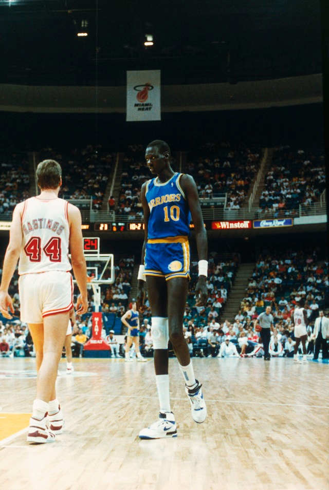 Manute Bol #10 of the Golden State Warriors looks on during a game against the Miami Heat in Miami, Florida.