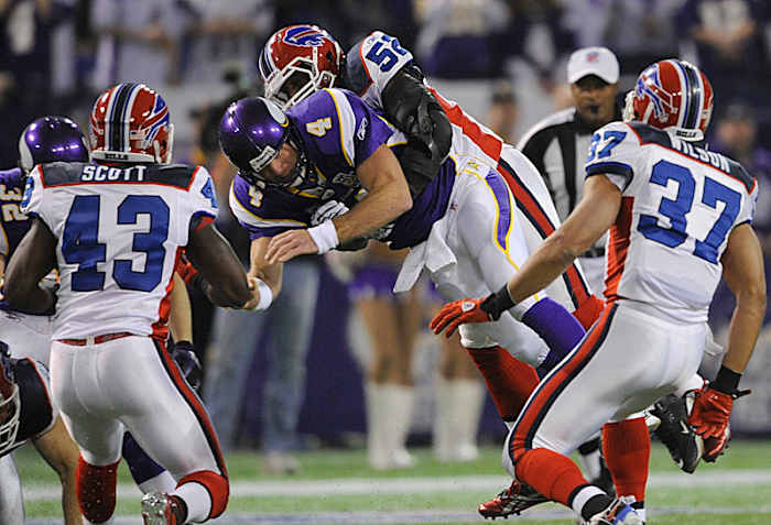 This hit from Arthur Moats ended Favre's 297th and final consecutive regular-season start after just one pass attempt. (Hannah Foslien/AP)