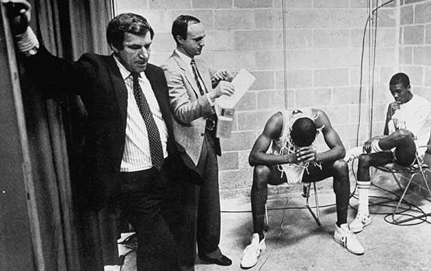 Dean Smith, SID Rick Brewer and players James Worthy (left) and Jimmy Black were the picture of tired, not triumphant, after the Tar Heels won the 1982 NCAA title.