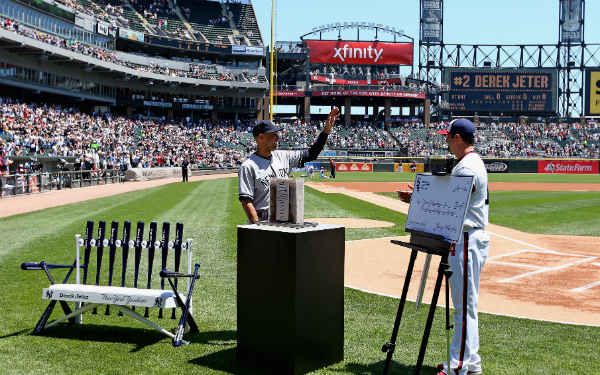 White Sox veteran Paul Konerko presented Derek Jeter with his farewell gifts on Sunday. (Jonathan Daniel/Getty Images)
