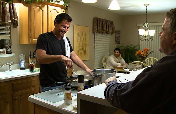 Gene Steratore, with son Geno in the background, in his kitchen a day after the Texans-Cardinals game in Arizona