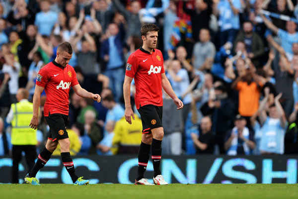 32-year-old Michael Carrick (right) struggled in the midfield against Yaya Toure. (Michael Regan/Getty Images)