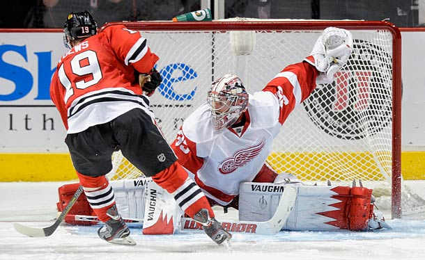 Jonathan Toews of the Chicago Blackhawks tries to beat Detroit Red Wings goalie Jimmy Howard