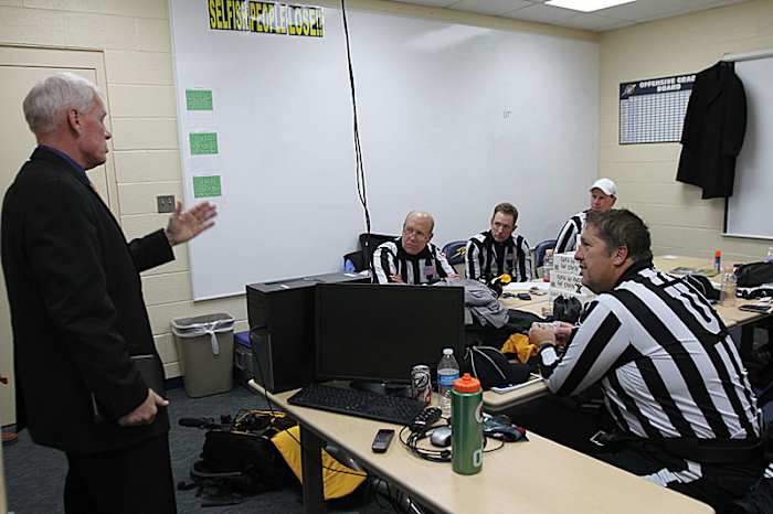 Bob Waggoner meets with the MAC officials he oversees before the Buffalo-Toledo game, two days after working Texans-Cardinals in Arizona.