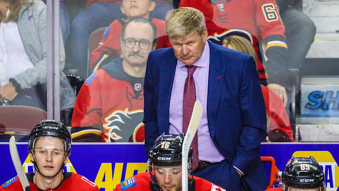 Flames coach Bill Peters on the bench