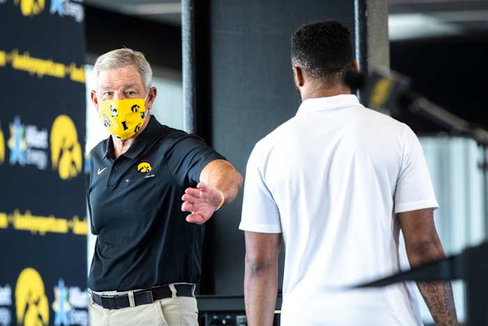 Iowa coach Kirk Ferentz talks to Djimon Colbert after Thursday's press conference. (Joseph Cress/Iowa City Press-Citizen for USA Today Sports)