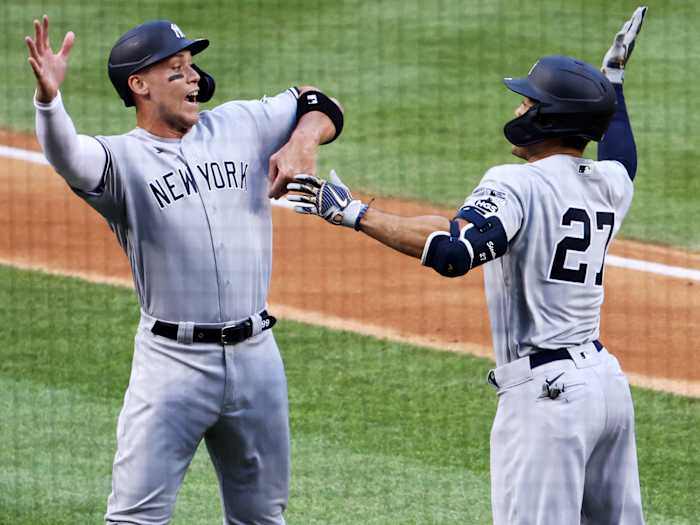 Jul 23, 2020; Washington, DC, USA;  New York Yankees designated hitter Giancarlo Stanton (27) celebrates with right fielder Aaron Judge (99) after hitting a two-run home run against the New York Yankees in the first inning during MLB Opening Day at Nationals Park.