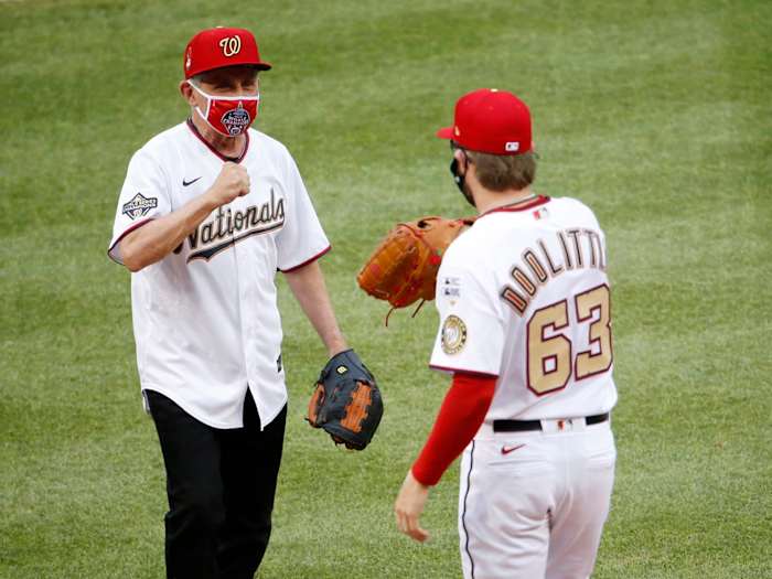 Jul 23, 2020; Washington, DC, USA; National Institute of of Allergy and Infectious Diseases director Dr. Anthony Fauci greets Washington Nationals relief pitcher Sean Doolittle (63) after throwing out the ceremonial first pitch before MLB Opening Day between the New York Yankees and the Washington Nationals at Nationals Park.