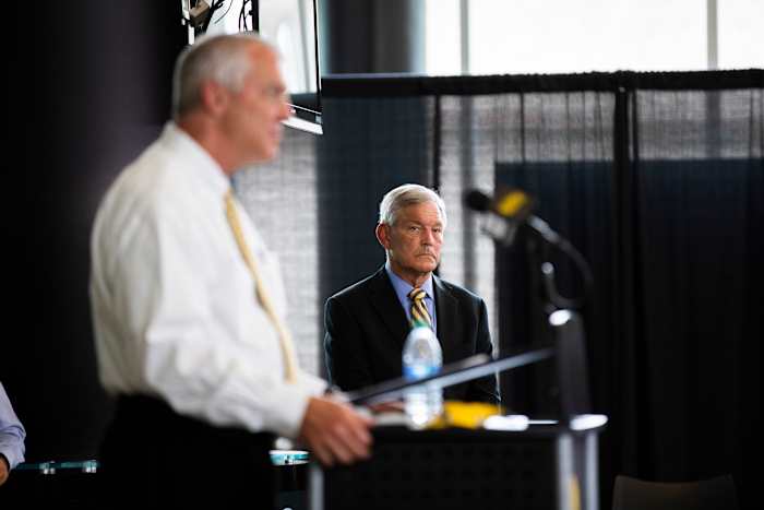 Iowa football coach Kirk Ferentz listens to athletic director Gary Barta speak during Thursday's press conference in Iowa City. (Katina Zentz/Iowa City Press-Citizen-Imagn Content Services)