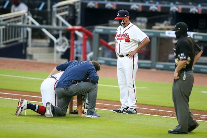 Braves manager Brian Snitker checks on starting pitcher Mike Soroka