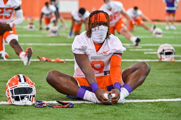 Clemson players warm-up Thursday wearing masks to protect themselves from Covid-19. Some Pac-12 and Big 10 players have said they will boycott the season if their respective conferences don't have a better plan to keep players safe this season.