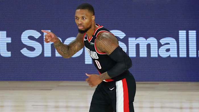 Portland Trail Blazers guard Damian Lillard (0) reacts after making a three point basket against the Dallas Mavericks during the second half of a NBA game at The Field House.