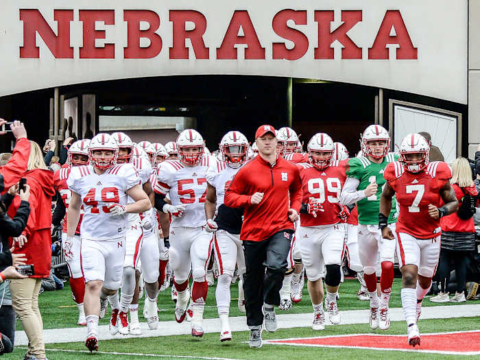 Nebraska football and coach Scott Frost run out of the tunnel