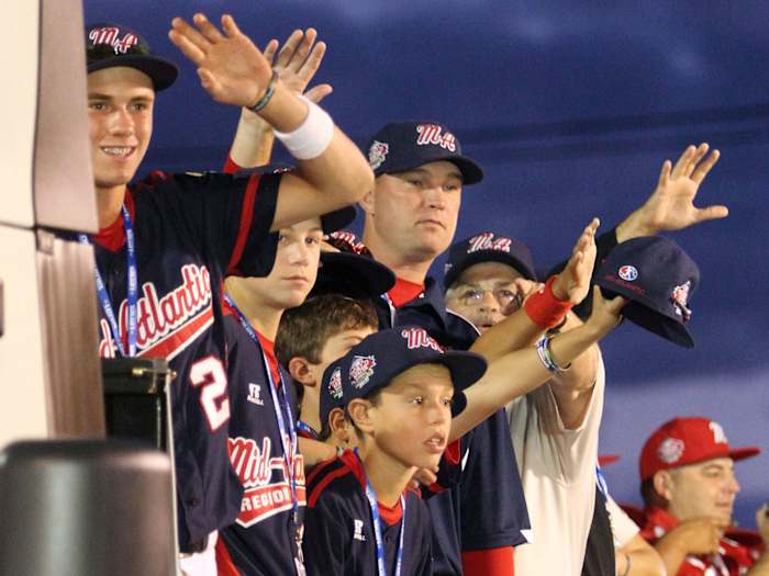 Little League players wave