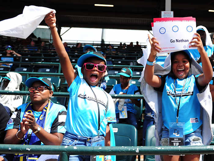 Two fans wave from the stands