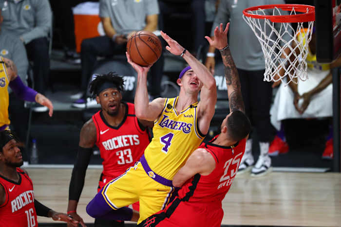Houston Rockets guard Austin Rivers (25) fouls Los Angeles Lakers guard Alex Caruso (4) in the first half in game four of the second round of the 2020 NBA Playoffs at AdventHealth Arena.