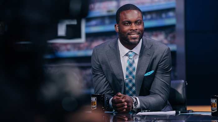 Michael Vick behind a broadcast desk