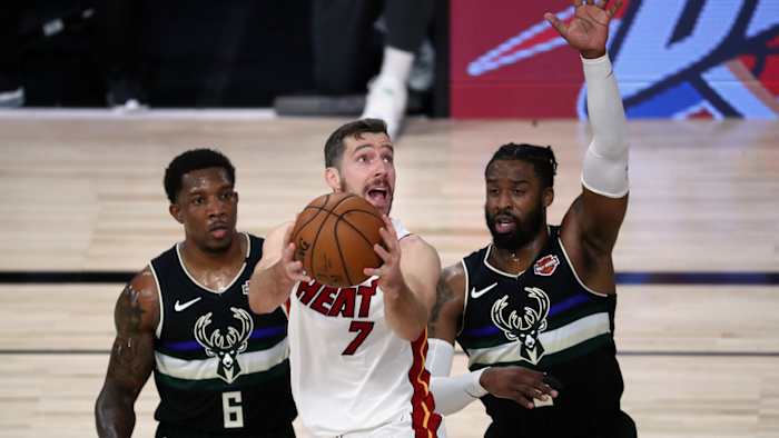 Miami Heat guard Goran Dragic shoots against Milwaukee Bucks guard Eric Bledsoe and guard Wesley Matthews during the first half of game two of the second round