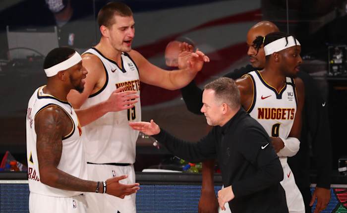 Denver Nuggets head coach Michael Malone celebrates with his team after defeating the Los Angeles Clippers in game seven of the second round of the 2020 NBA Playoffs