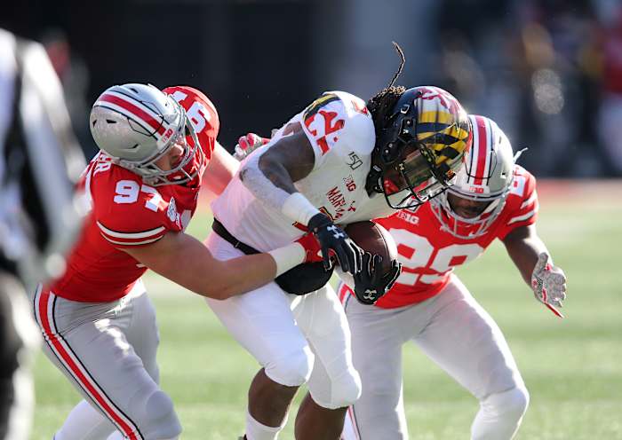Noah Potter (97) makes a tackle, with help, against Maryland in 2019.