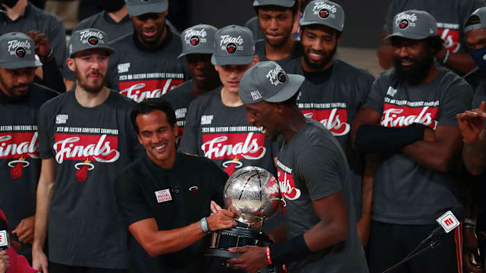 Miami Heat head coach Erik Spoelstra hands the Eastern Conference Championship trophy to forward Bam Adebayo (13) after defeating the Boston Celtics in game six of the Eastern Conference Finals of the...
