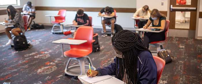 Students attend class at Indiana University with masks on and 6-feet apart.