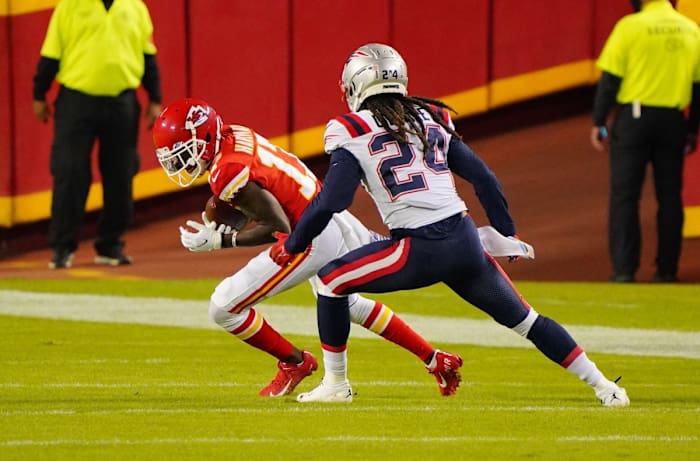 Oct 5, 2020; Kansas City, Missouri, USA; Kansas City Chiefs wide receiver Mecole Hardman (17) runs the ball against New England Patriots cornerback Stephon Gilmore (24) during the third quarter of a NFL game at Arrowhead Stadium. Mandatory Credit: Jay Biggerstaff-USA TODAY Sports