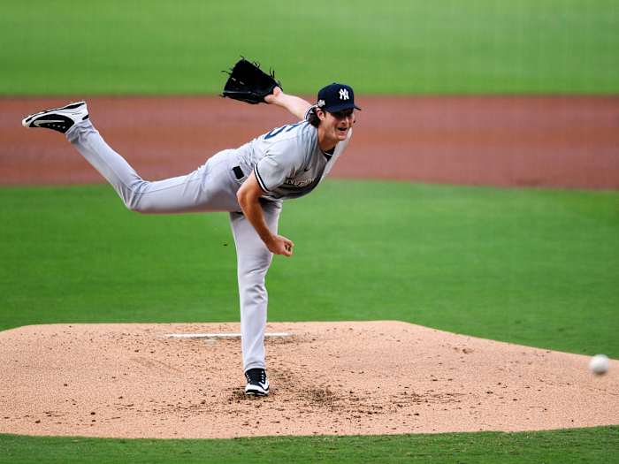 Oct 5, 2020; San Diego, California, USA; New York Yankees starting pitcher Gerrit Cole (45) pitches against the Tampa Bay Rays during the first inning in game one of the 2020 ALDS at Petco Park.