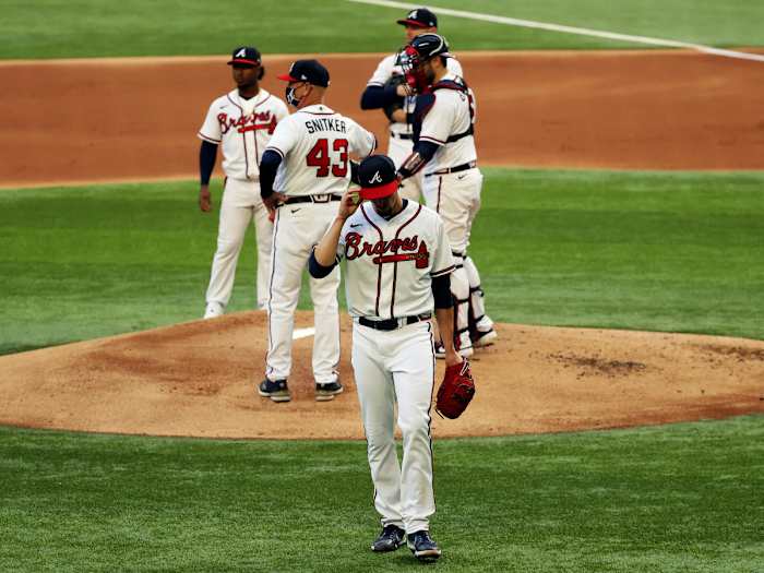 Oct 14, 2020; Arlington, Texas, USA; Atlanta Braves starting pitcher Kyle Wright (30) reacts after being removed from the game by manager Brian Snitker (43) during the first inning of game three of the 2020 NLCS against the Los Angeles Dodgers at Globe Life Field.