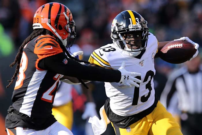 Steelers wide receiver James Washington stiff arms Bengals cornerback B.W. Webb on a touchdown catch and run in the third quarter of an NFL Week 12 game, Nov. 24, 2019, at Paul Brown Stadium in Cincinnati.