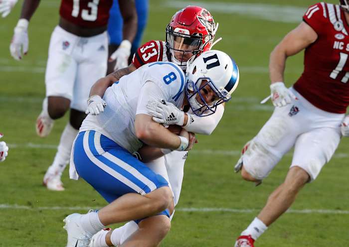 Isaac Duffy makes a tackle on Duke quarterback Chase Brice