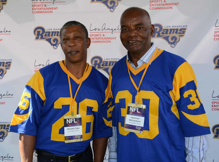 Former Rams running backs Wendell Tyler (26) and Lawrence McCutcheon (30) pose at an NFL All-Access event at the Los Angeles Memorial Coliseum in 2016.